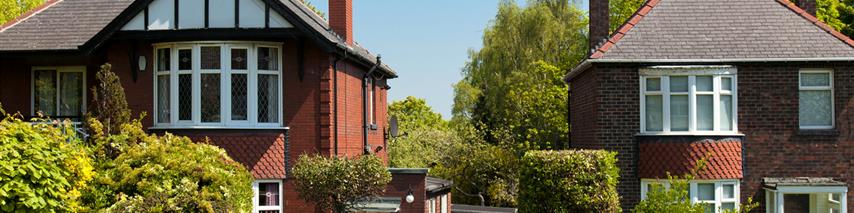 Two detached houses on sunny day