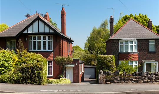 Two detached houses on sunny day